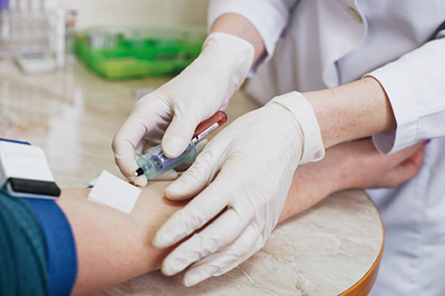 Cropped Hands Of Doctor Injecting Syringe On Patients Hand During Blood Test