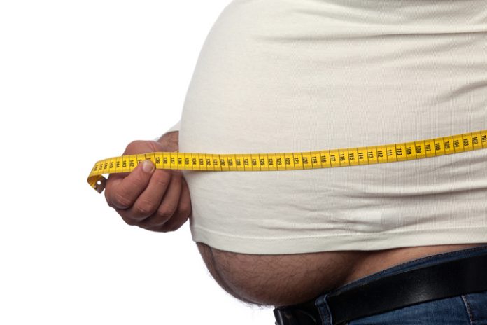 Large Built Man Measuring His Big Belly With Yellow Tape