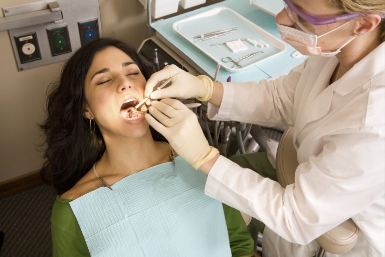 Dentist examining patient teeth, elevated view