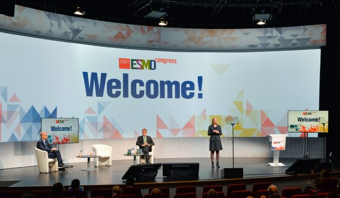 Picture of the start of the ESMO21 virtual cancer conference - stage with speakers and podium