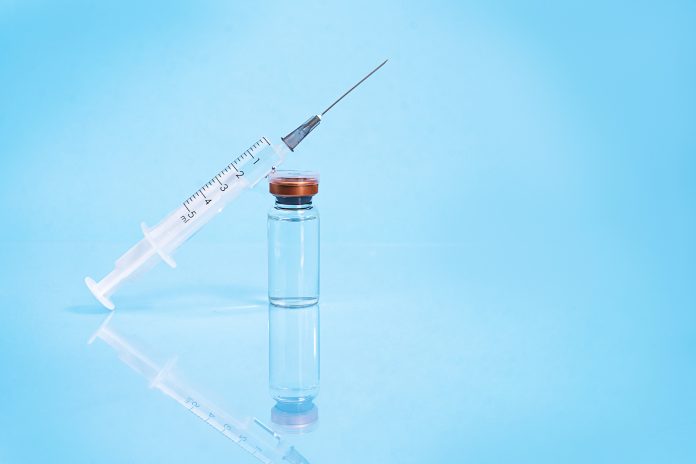 Vial with syringe to signify drug or vaccine that needs to be injected