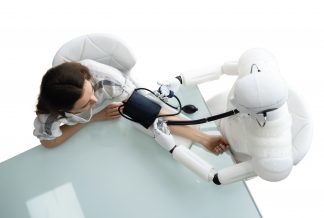 Robot taking woman's blood pressure