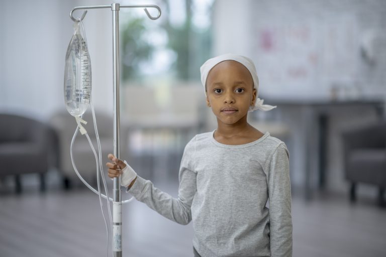 Little Girl with Cancer Holding her IV Pole