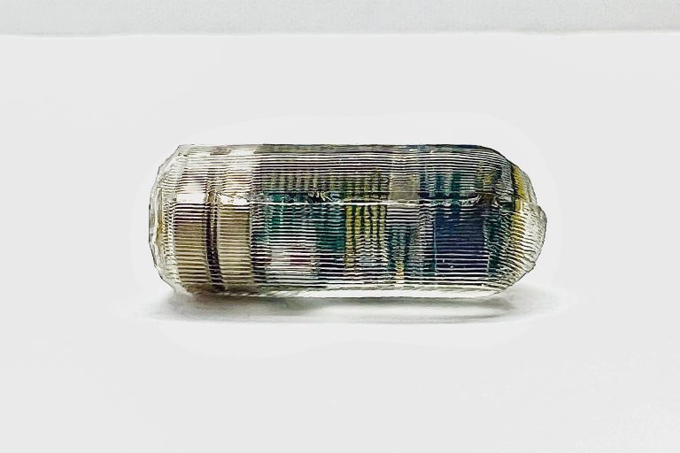 Photo of tiny ingestible sensor whose location can be monitored as it moves through the digestive tract