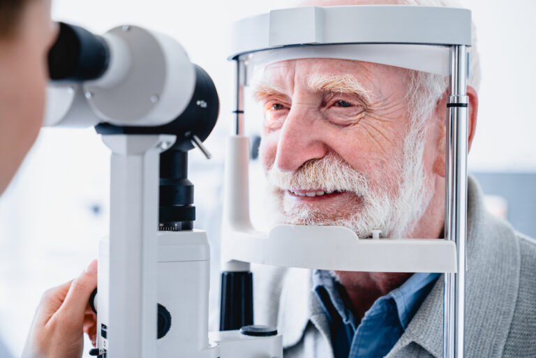 Close up photo of older male patient undergoing a sight examination to assess eye diseases which can be linked to Alzheimer's disease