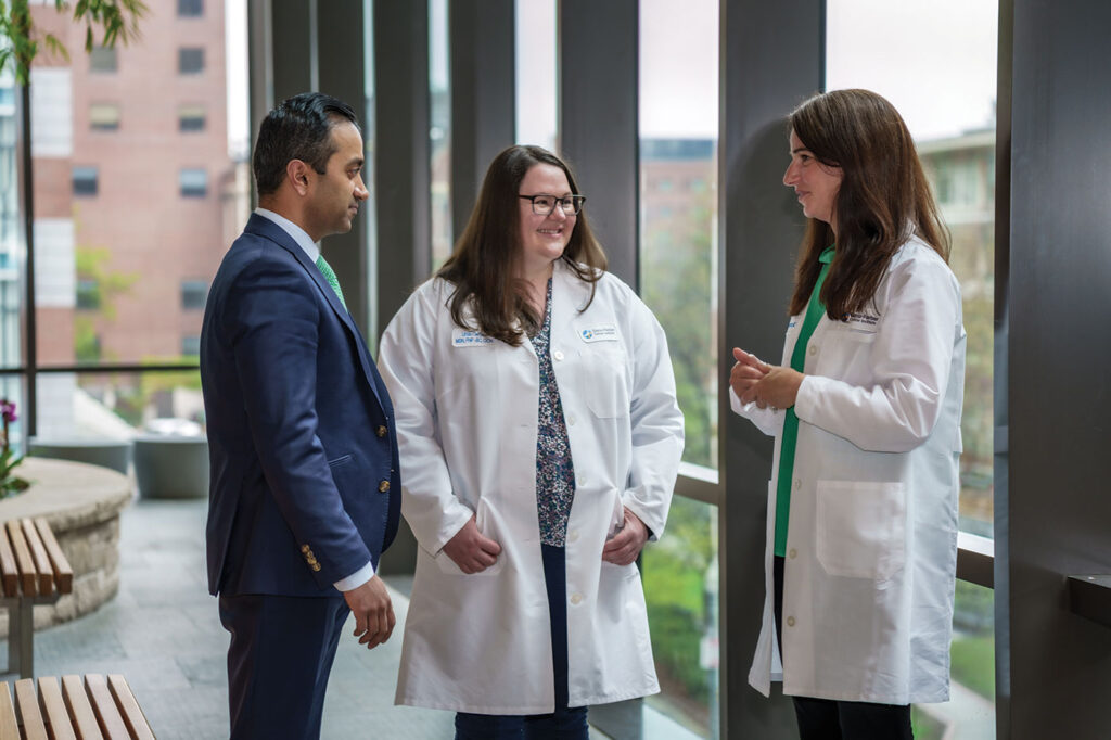Omar Nadeem, MD, chats with colleagues
