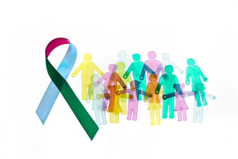 Colorful rare disease awareness ribbon with a group of different colored sillouettes symbolizing people with rare diseases.