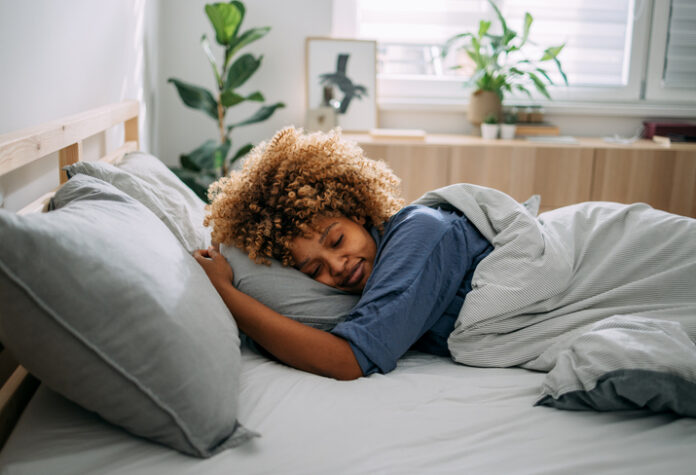 1388450667 Beautiful Woman Sleeping in her Bedroom in the Morning